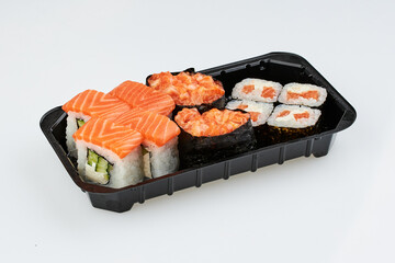 Close-up of sushi rolls made of sausage and covered with cabbage and ketchup. Homemade asian style. Sushi-food hybrids trend. Japanese food.