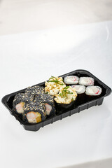 Close-up of sushi rolls made of sausage and covered with cabbage and ketchup. Homemade asian style. Sushi-food hybrids trend. Japanese food.