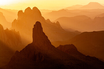 Hoggar landscape in the Sahara desert, Algeria. A view from Assekrem of the sunrise over the Atakor mountains - 750082045
