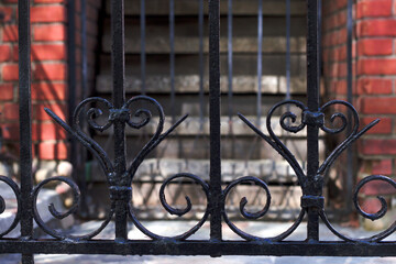 wrought fence near building entrance in the city