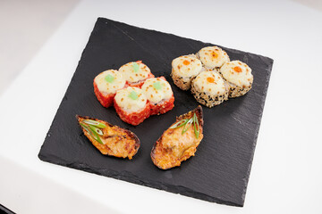 Close-up of sushi rolls made of sausage and covered with cabbage and ketchup. Homemade asian style. Sushi-food hybrids trend. Japanese food.