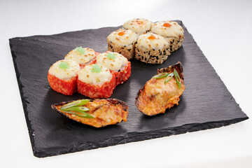 Close-up of sushi rolls made of sausage and covered with cabbage and ketchup. Homemade asian style. Sushi-food hybrids trend. Japanese food.