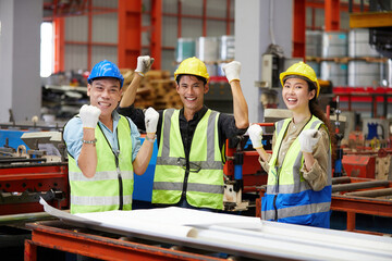 workers team raise hands up for success work or project in the factory