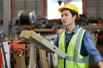 factory workers or engineer smiling and pushing button switch machine control in the factory