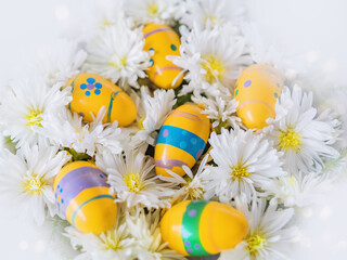 Decorative Easter eggs lie in white flowers. Church Christian holidays, Christianity, Easter background