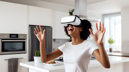 A laughing African American girl wearing virtual reality glasses in a modern kitchen, dressed in a white T-shirt, emotionally gesticulates with her hands while controlling the application. copy space