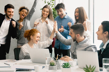 Business team celebrating success together on workplace
