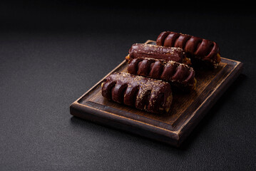 Delicious sweet chocolate cakes with fruit filling and sprinkles on a ceramic plate