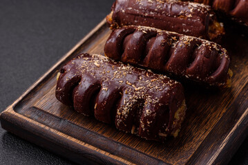 Delicious sweet chocolate cakes with fruit filling and sprinkles on a ceramic plate