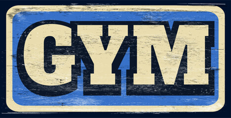 Aged and distressed gym sign on wood