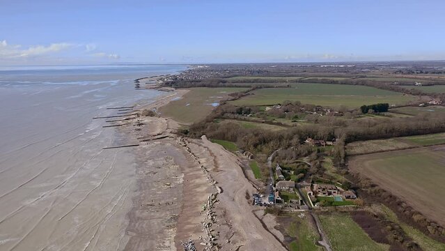 Aerial footage of Atherington and Climping beach in West Sussex and the broken sea defence and the temporary shingle bank in place to protect the land.