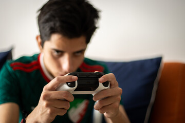 young man playing video games in the afternoon