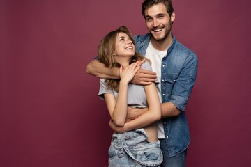 Happy loving couple isolated isolated on red background.