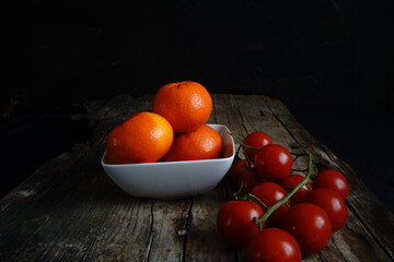 Still life photography with cherry tomatoes and mandarins