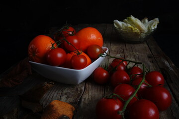 Still life photography with cherry tomatoes and mandarins