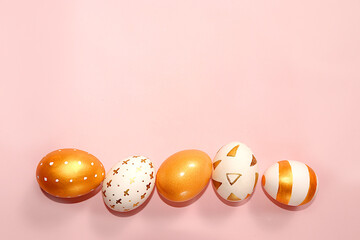 Decorated golden Easter eggs on a pink background. . Happy Easter background,banner. Creative...