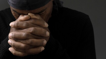 black man praying to god with hands together Caribbean man praying with people stock image stock...