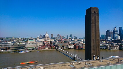 London, UK - 05.15.2018: Skyline from Tate Modern rooftop to the Millennium Bridge and St. Paul's Cathedral under a clear sky