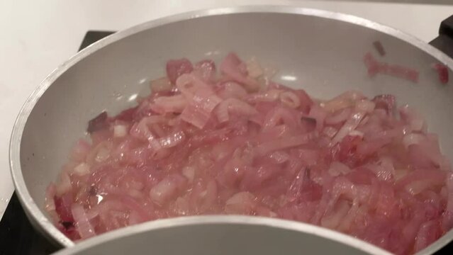 the chef completes the preparation of the caramelized onions
