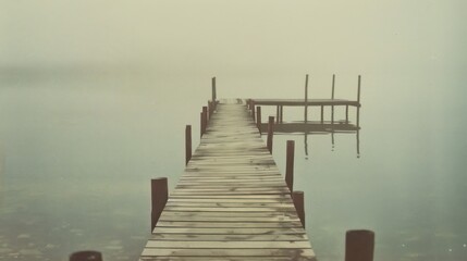 Naklejka premium Classic photos of a small dock from the past evoke an old-fashioned charm, mysterious, with tranquil colors that harken back to Polaroid images.
