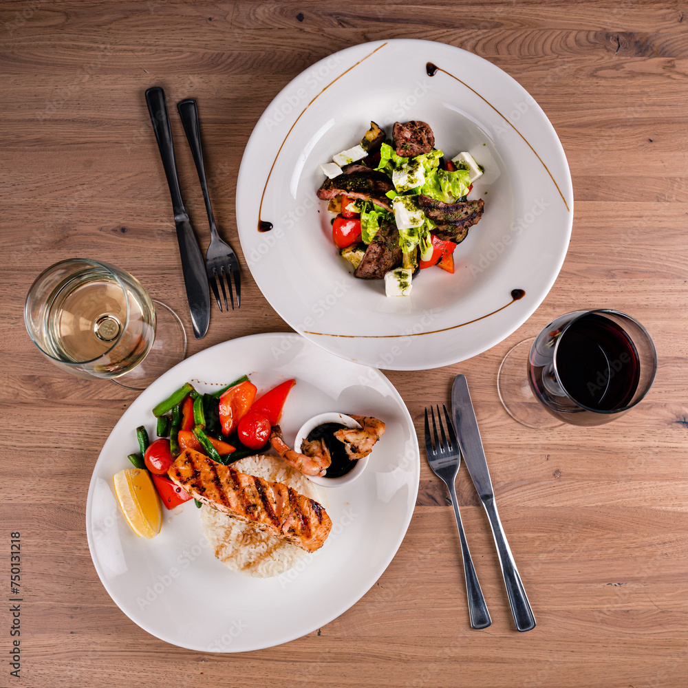 Sticker grilled salmon fish with rice and vegetables and beef salad.