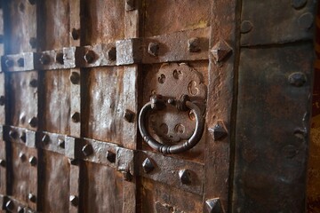 A medieval building of the 17th century. Door with forged metal trim