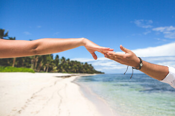Close-up Friendship Hands Beach Connection. Reaching hands on a sunny beach symbolizing connection, ideal for travel or friendship themes.