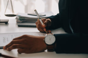 Justice and Law concept. Legal counsel presents to the client a signed contract with gavel and...