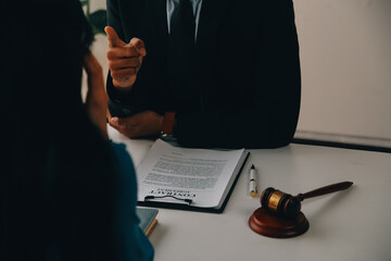 Justice and Law concept. Legal counsel presents to the client a signed contract with gavel and...