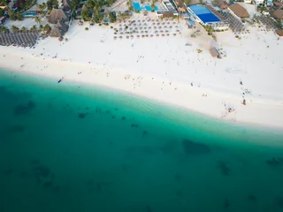 Foto auf Acrylglas Nungwi Strand, Tansania Top view of beach and clear green water on tropical sea coast with sandy beach.Summer travel in Zanzibar, Africa,Tanzania.