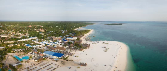 Foto auf Acrylglas Drone view of beach and clear green water on tropical sea coast with sandy beach.Summer travel in Zanzibar, Africa,Tanzania. © robertobinetti70