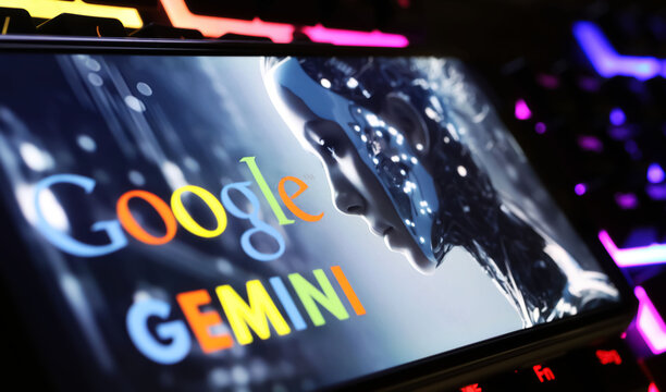 Viersen, Germany - February 9. 2024: Closeup of Smartphone screen with logo lettering of Google Gemini on computer keyboard
