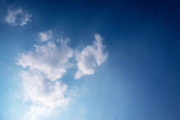 blue sky with white clouds sunray background