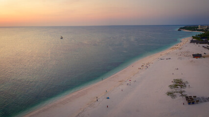 Zanzibar beach at sunset,where tourists and locals mix together of colors and joy, concept of summer vacation, aerial view of Kendwa beach, Tanzania