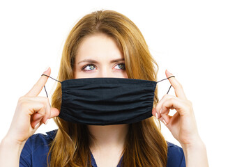 Woman using protective face mask.