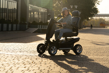 Woman tourist riding a four wheel mobility electric scooter on a city street