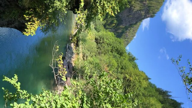 The Bolshaya Laba River. A mountain emerald river in a narrow, sunlit canyon. Bolshaya Laba River near the village of Psemen in Karachay-Cherkessia, Russia. Panoramic view. 4K