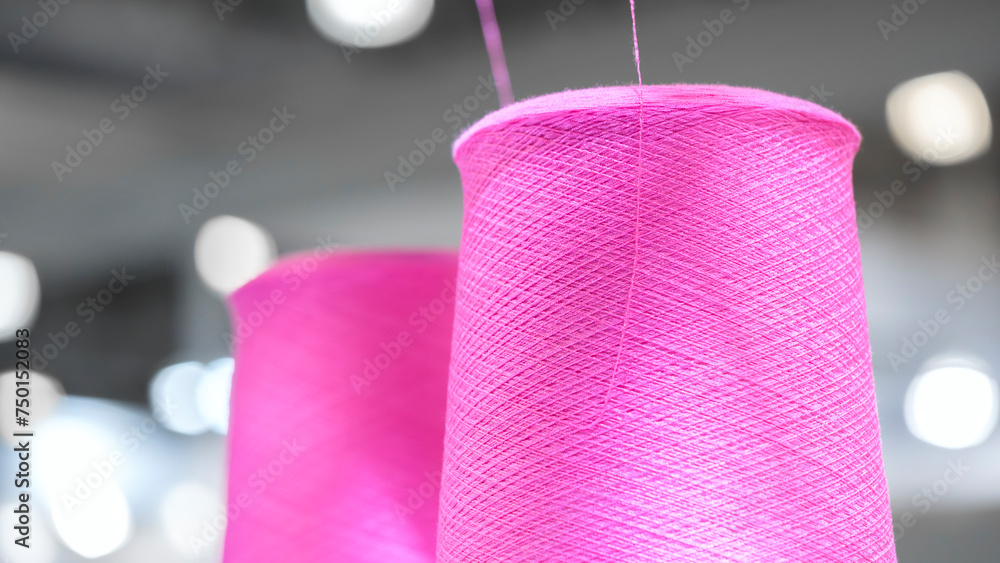 Poster spools of color threads closeup for spinning machine