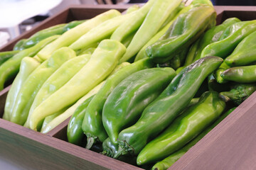 A pod of green hot pepper on a tray in a store or market - 750152038