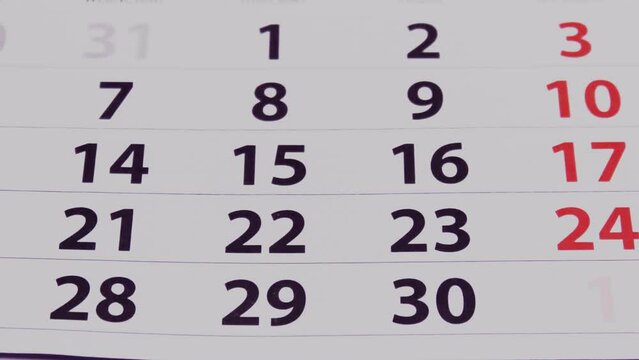 Calendar pages turning close up, weeks and months changing fast