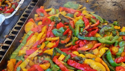 Red green and yellow peppers seasoned with oil at restaurant