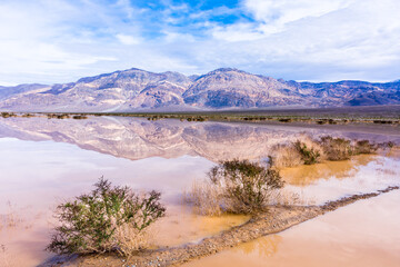 Flooded Death Valley National Park, California, on the Nadeau Trail with mountain reflections