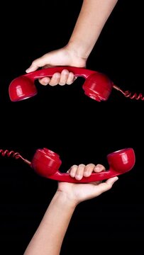 red vintage telephone handsets in vertical