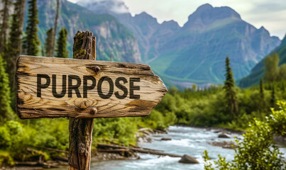 Rustic wooden signpost with the word PURPOSE pointing forward against a backdrop of majestic mountains and river, symbolizing direction, goal setting, and life's journey