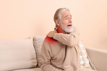 Man suffering from rheumatism at home. Space for text