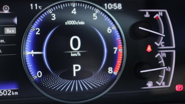 Car tachometer engine revving needle indicates redline speed vibration. Performance Racing Car Dashboard. Tachometer Showing Performance. Dashboard in the car. The car pics up speed, tachometer.