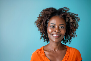 African American Mid-Aged Woman Smiling on Isolated Background. Beautiful Brown Skin Woman in her Sixty Smiling.