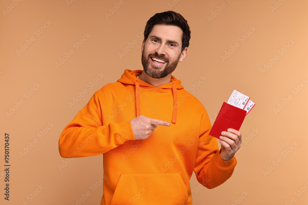 Sticker smiling man pointing at passport and tickets on beige background