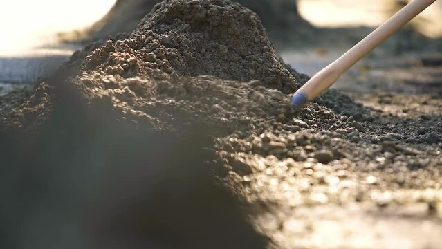 Digging soil with shovel. Worker digs the ground with a shovel. Shovel Digs a Underground Hole with a Shovel at the construction site.