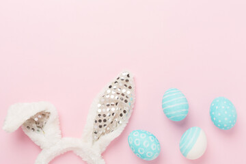 Blue easter eggs with bunny on color background, top view
